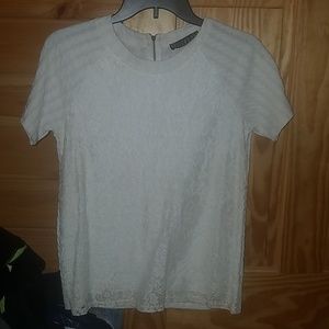 An elegant detailed cream top with light speckles.
